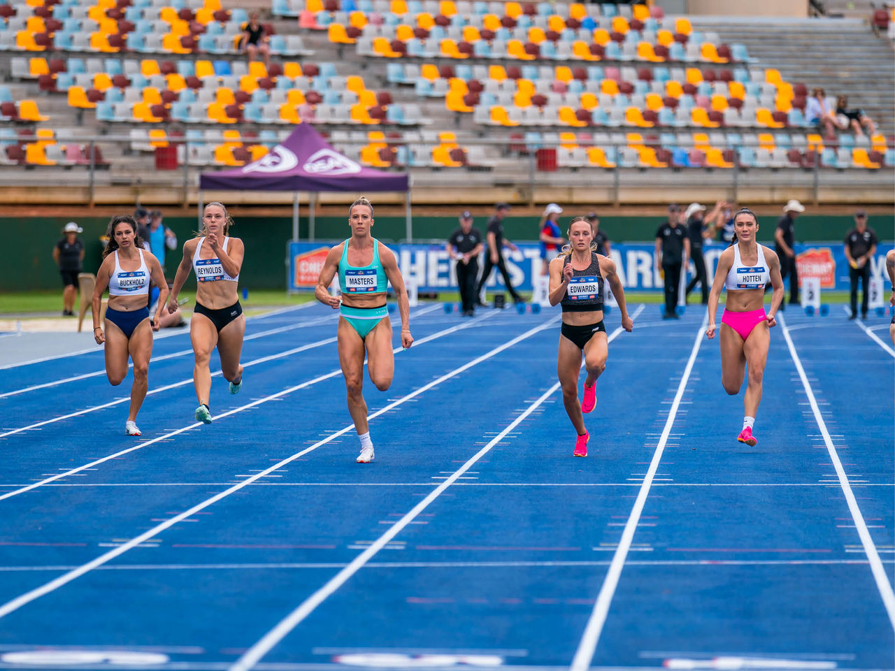 Athletes Running Down Front Straight of Main Stadium